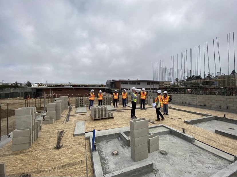 ElSegundoUSD's tweet photo. Progress on construction of the @ElSegundoMiddle School Gymnasium this week! The CMU block walls have started going up. The structural engineer was on site to inspect the first block lift. ESUSD Superintendent, BOE & FAC members toured the site to review progress. #MeasureES https://t.co/KQcCPP4GNr
