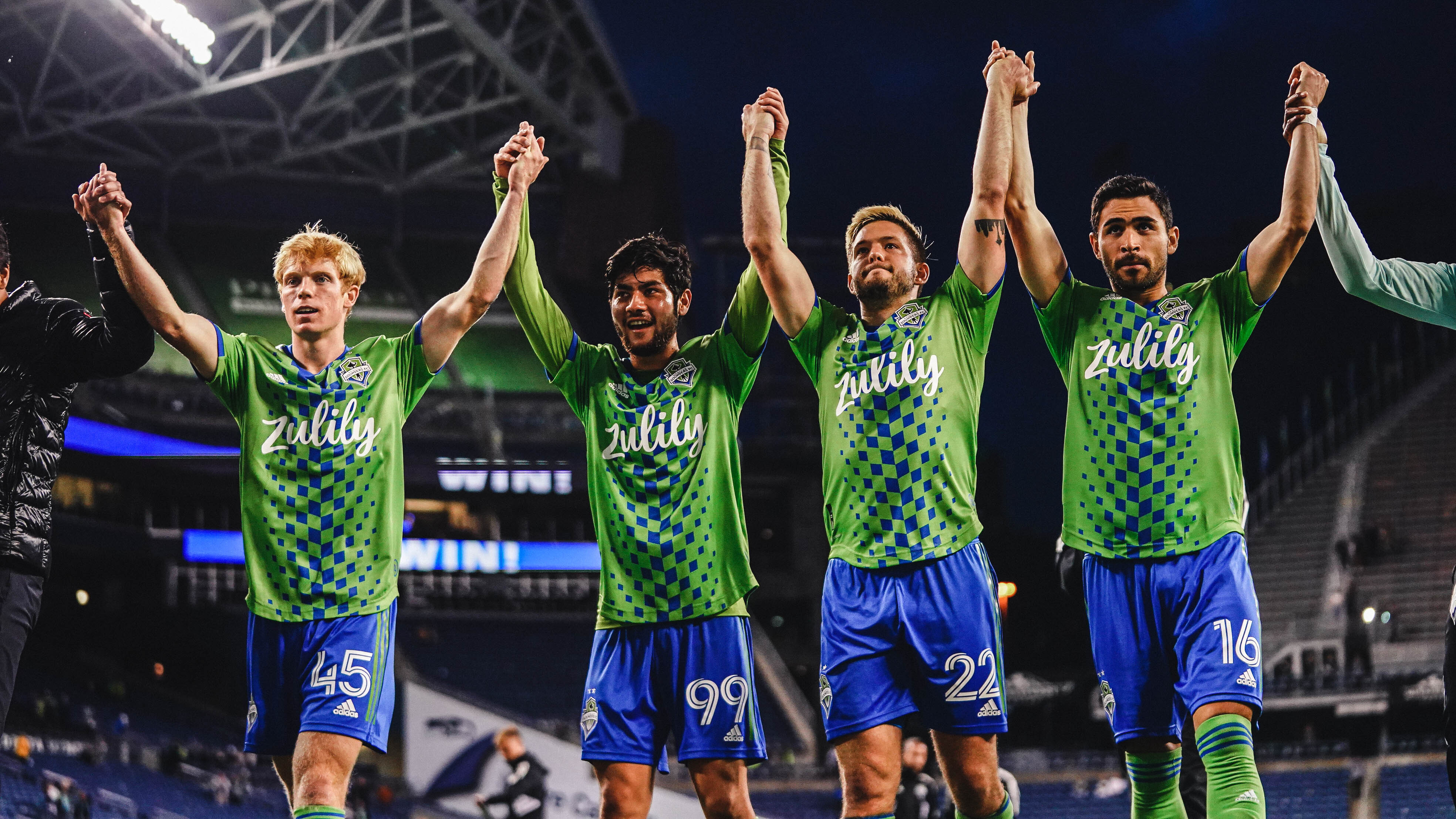 Sounders players celebrating a win