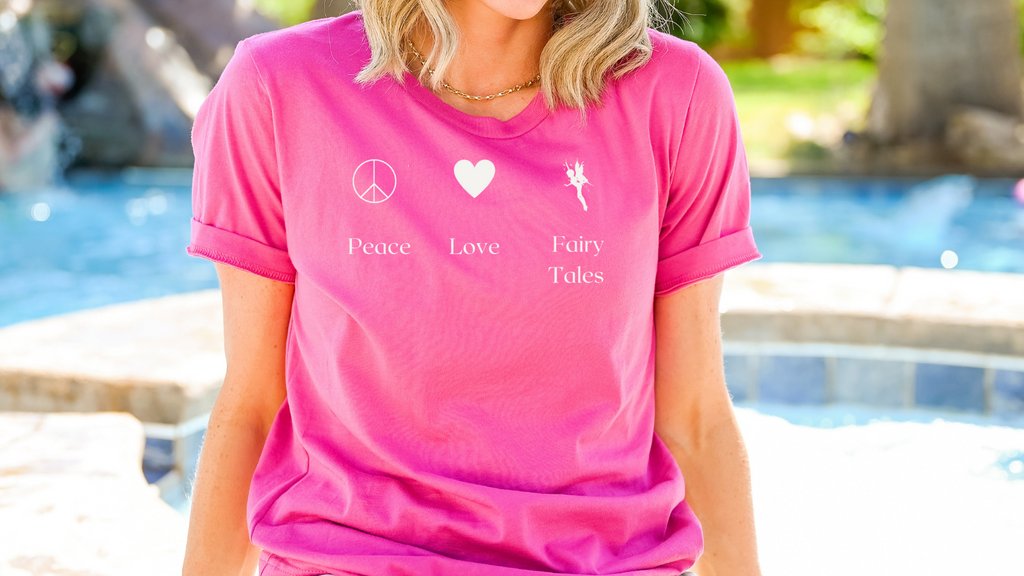 The Peace, love &amp; fairy tales tee is everything you've dreamed of. It's soft &amp; lightweight, w the right amount of stretch. It's comfortable &amp; flattering for all. Check out our link tree 4 more details. 

 #bookmerch #booknerdmerch #Ofelvesandaliens #fairytales #fantasy #tshirts