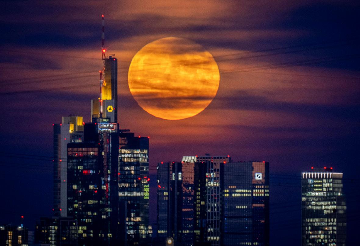 From Spain to Turkey, eyes were turned to the massive strawberry supermoon painting the night sky a reddish hue overnight on Wednesday. 

A supermoon is when the moon is at its closest to Earth during its orbit.