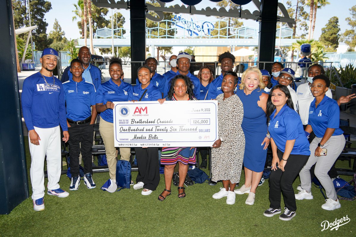 Dodgers's tweet photo. The Dodgers and @DodgersFdn hosted @BCrusade at Dodger Stadium for their annual Juneteenth Circle. As part of #50FeedsLA, LADF and @mookiebetts presented them with a $126,000 check to help those experiencing food insecurity. https://t.co/BsZ0MkWlGS