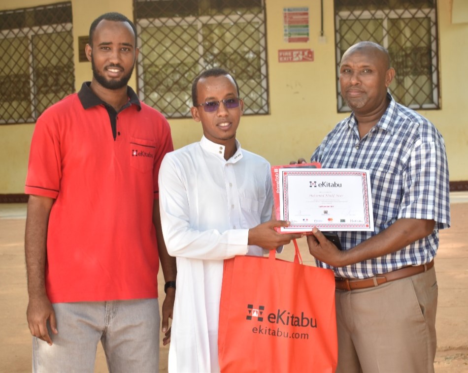 ekitabu's tweet photo. Today we are celebrating Mohamed Khalif Noor (center), Digital Essay Competition (DEC) 2021 winner in the English Secondary category. Mohamed is a student at Mandera Secondary School in Mandera County. #DECWinners #essaywriting https://t.co/Qag0ujX49Y https://t.co/UoOcM0e6ZN