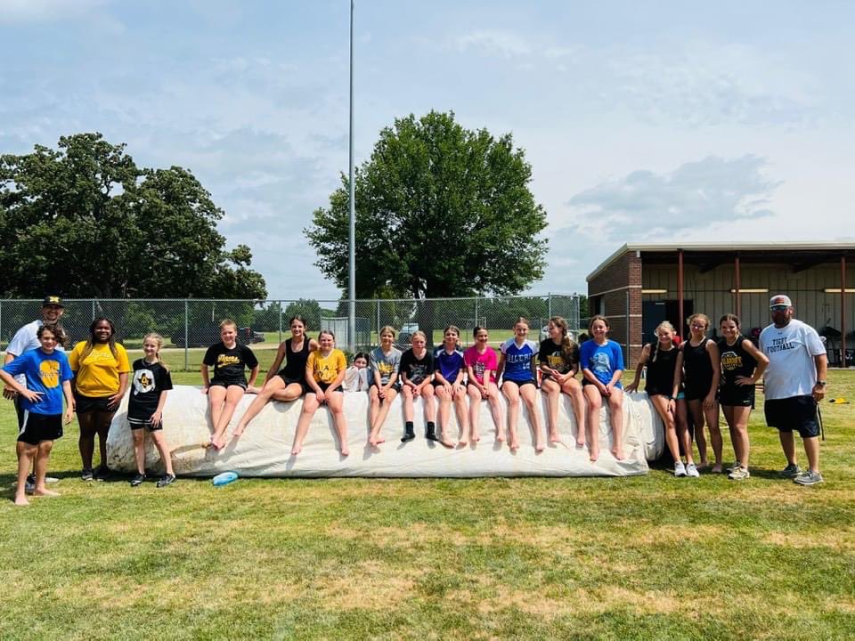Future Tigers practicing sliding at camp. Slip &amp; Slide on the tarp!