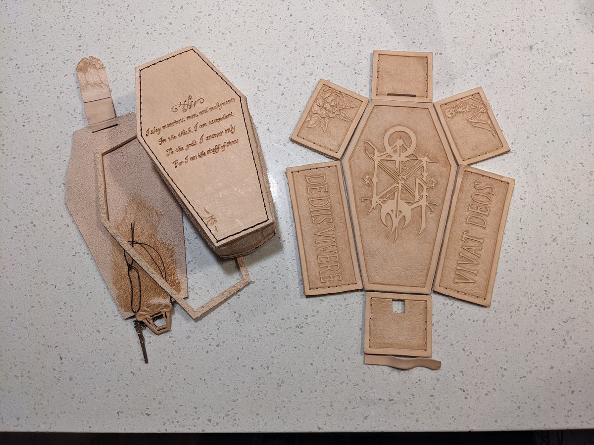 Here's some leather craft that I'm particularly proud of- custom coffin business card box for an occult shop. 
The sigil on the top and incantation on the back were created by the shop owner. The pattern and embellishments were mine.