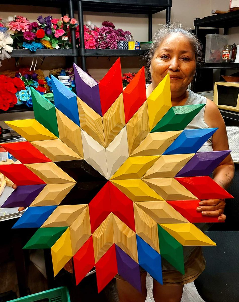 Stephen Francis of Eskasoni First Nation created this 8 point star with the LGBTQ2S community's flag colors. His wife barb francis holds it up to display. #EightPointStar #LGBTQIA2S #Eskasoni