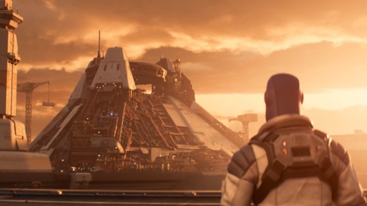 A still from Lightyear. Buzz looks off into the distance at the launch building.