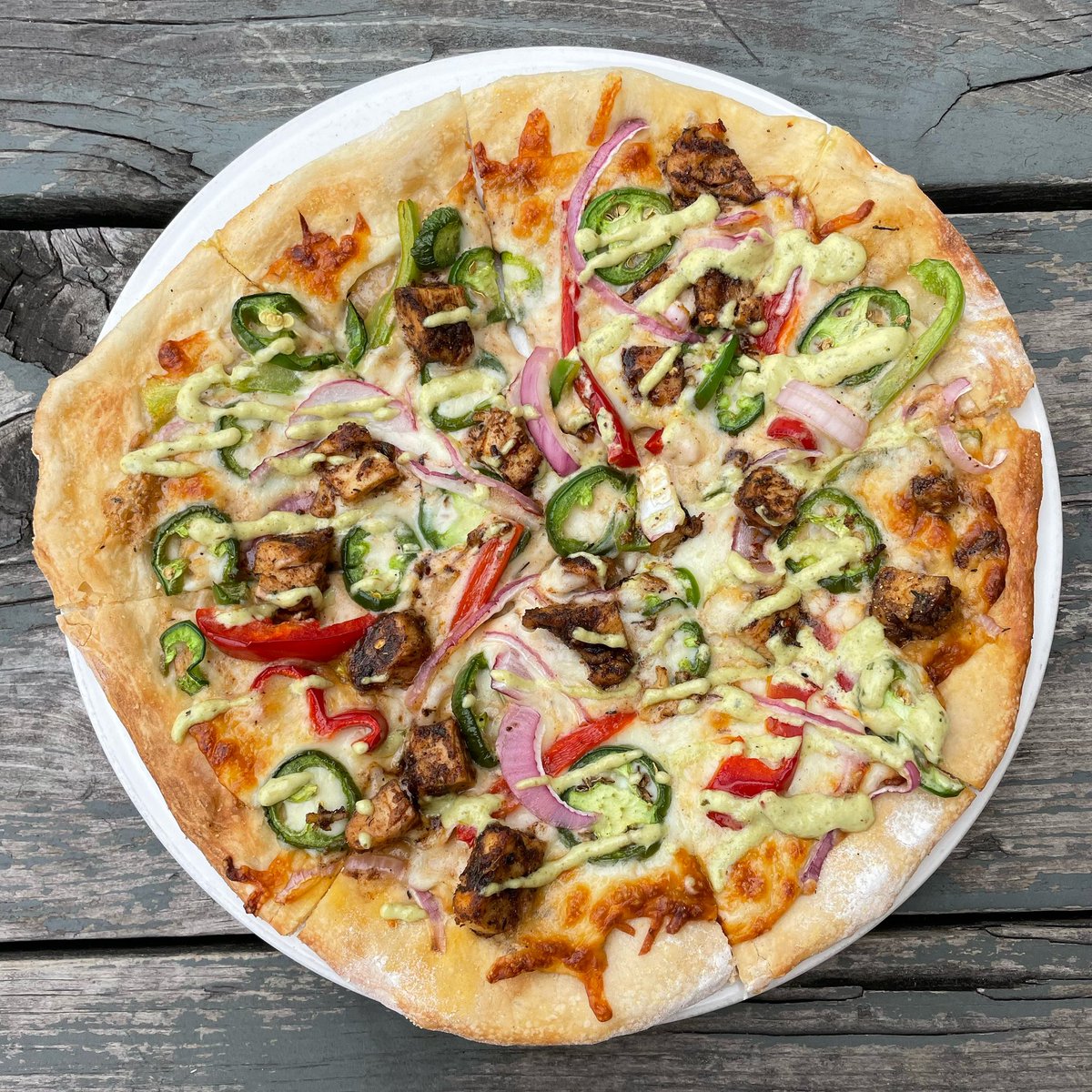 TheToastedFrog's tweet photo. We’ve added a couple new pizzas to our menu! Featured here is the Jamaican jerk pizza. It has a jerk spiced béchamel cream sauce base, fresh jalapeños, red onions and bell peppers, mozzarella and then finished with a roasted poblano aioli. #jamaicanjerk #toastedfrog https://t.co/lctIzNQwy6