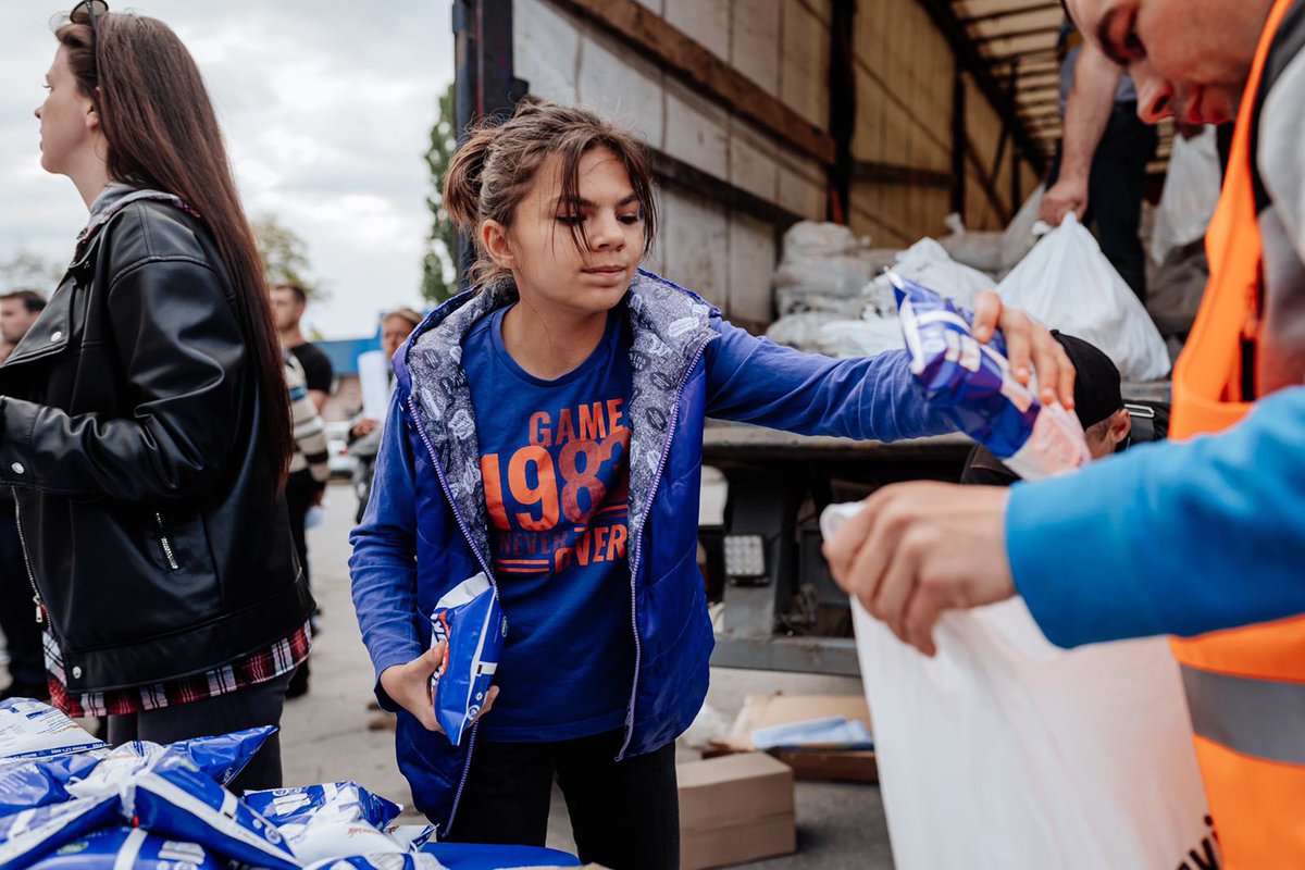 WCKitchen's tweet photo. 12 year-old Yana is from Lysychansk &amp; fled the bombs with her mom’s friend—who adopted her because her mom can’t leave. Yana told us she wanted to help distribute food, so she joined our team! Her dream before war was to learn photography &amp; WCK photographer Mike gave a lesson! 📸 https://t.co/4whhsBE0l2