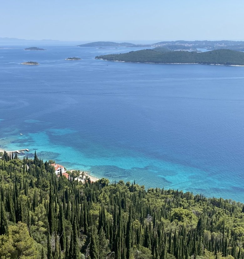 Rob_Griffin's tweet photo. View of Lumbarda in the distance from midway up Sveti Ilija. You can see the contrast between sand/rock and sea grass well here. One of the challenges with sea grass restoration in touristy areas like this is that there’s an aesthetic preference for the electric blue sand bottom. https://t.co/v2vUY4LAOy