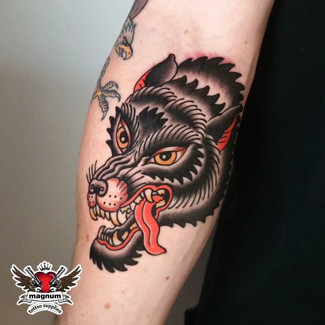 Bright wild fierce symmetrical wolf head and rose on upper inner arm  Traditional color tattoo David Bruehl  Traditional tattoo Trendy tattoos  Body art tattoos