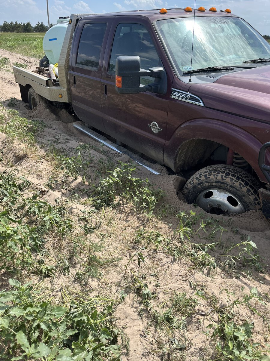 korynkoinzan's tweet photo. I got the fertilizer tank stuck, unhooked my pickup. Told my boy to hook up this pickup to see if it could pull it. When I showed up he said, “mom don’t be mad, all I could remember is papa Bart said, once you start don’t ever stop!”😣 I simply  replied, “only if it’s moving”!🤦🏼‍♀️ https://t.co/2ZMNUYKGf5