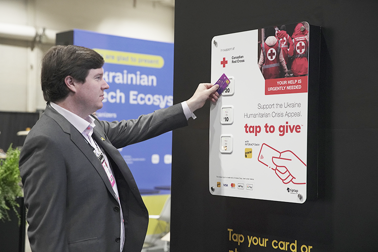 INTERAC's tweet photo. Come stop by our donation wall at @CollisionHQ  In partnership with @nanoleaf and @tiptappay, we are matching donations up to $25,000 in support of @redcrosscanada relief efforts for those impacted by the humanitarian crisis in Ukraine. https://t.co/FiXyA1K0U8