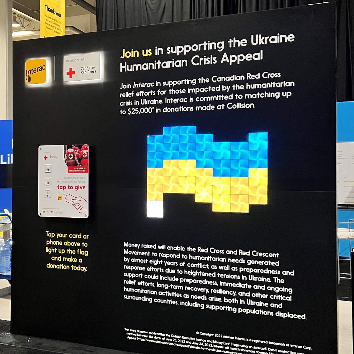 INTERAC's tweet photo. Come stop by our donation wall at @CollisionHQ  In partnership with @nanoleaf and @tiptappay, we are matching donations up to $25,000 in support of @redcrosscanada relief efforts for those impacted by the humanitarian crisis in Ukraine. https://t.co/FiXyA1K0U8