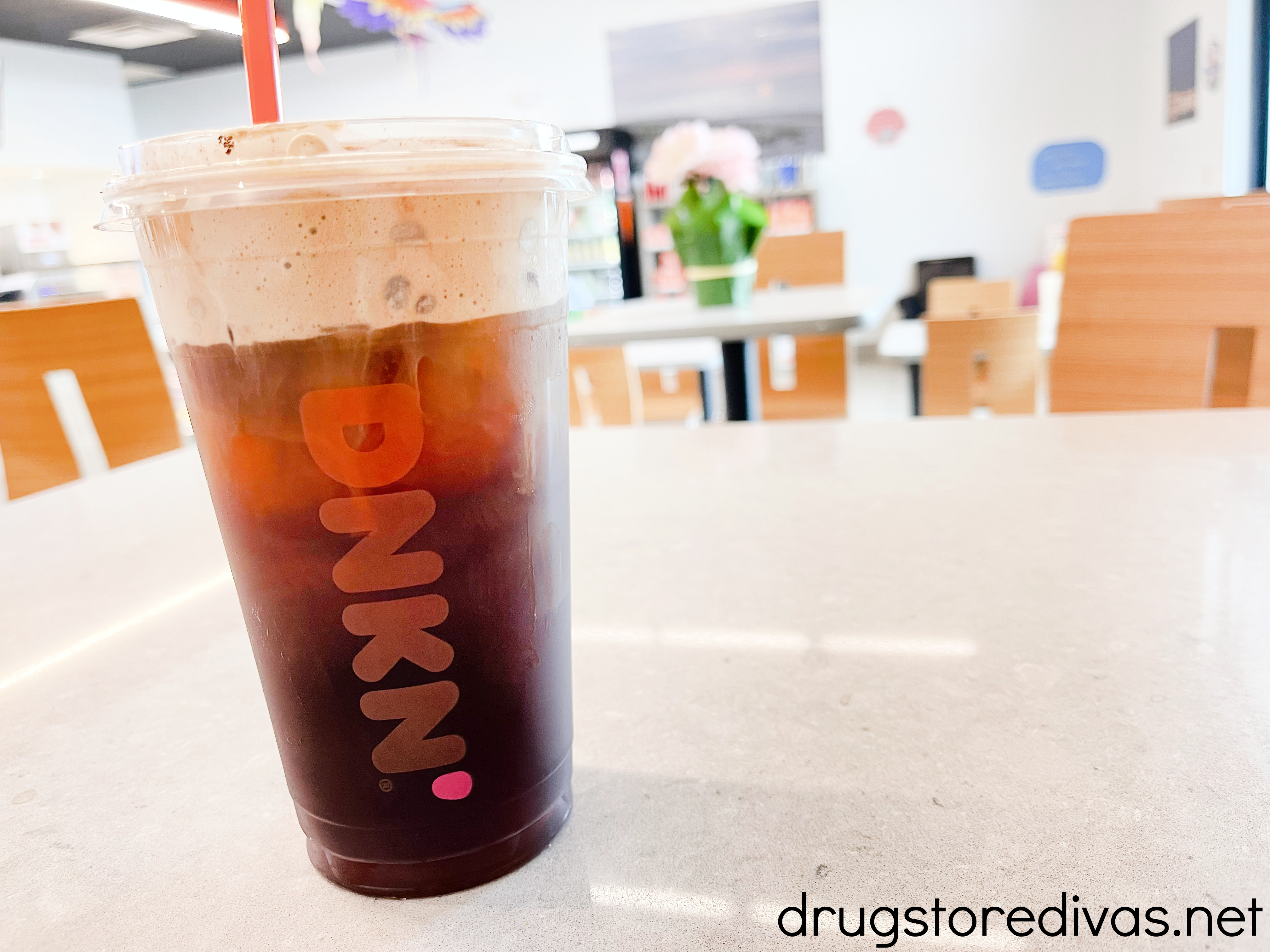 An iced Dunkin' cold brew coffee with cold foam.