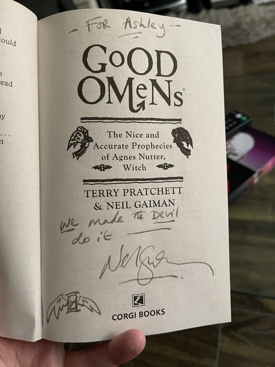 AshleyRGood's tweet photo. My cousin worked on Season 2 of Good Omens and she gave me this extremely kind gift last weekend. Thank you @neilhimself. Shiny new signed copy alongside my dog-eared 1991 copy. https://t.co/rPSuPj9lY8