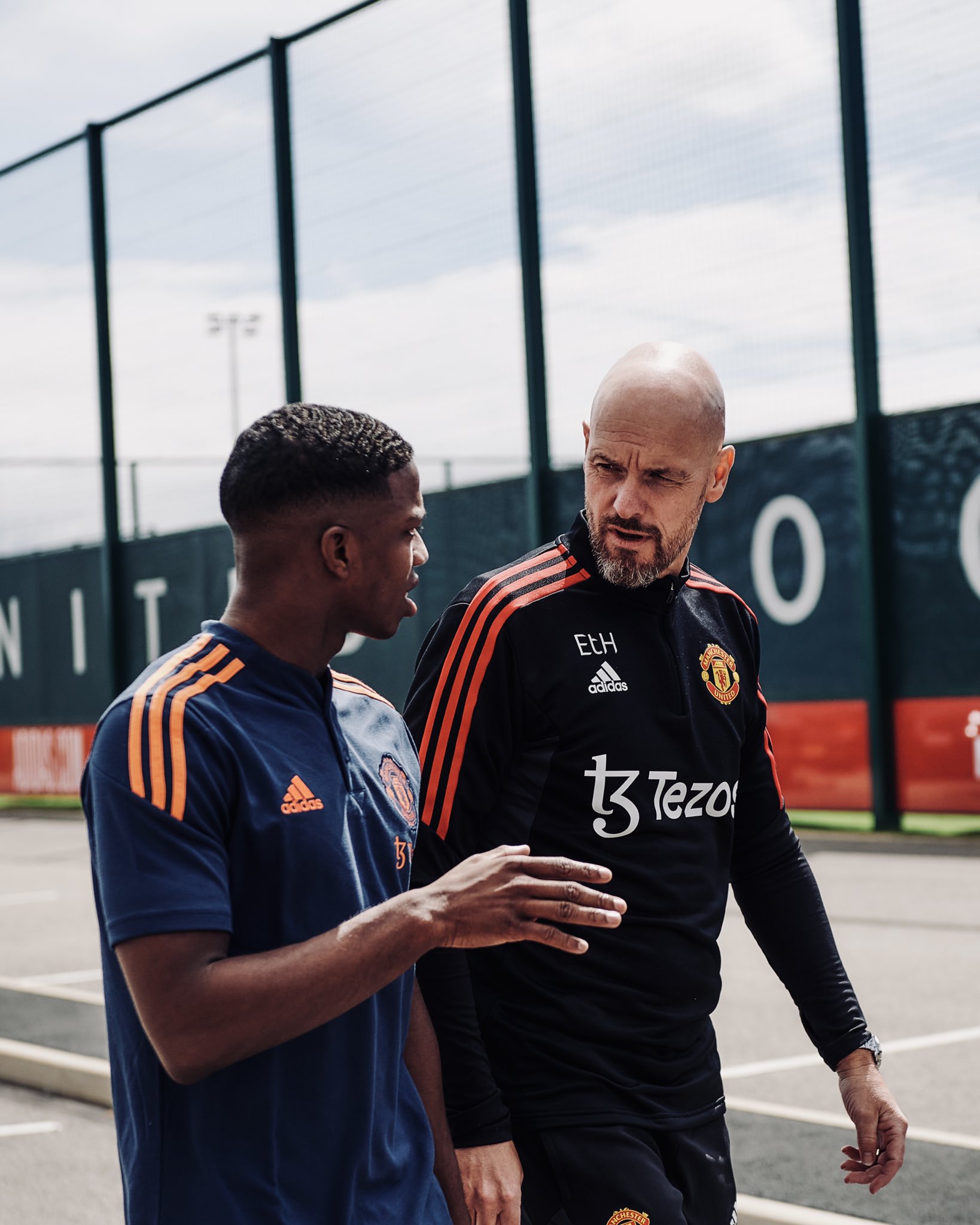 Tyrell Malacia speaks to Erik ten Hag at Carrington.