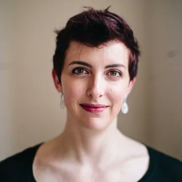 Image of a woman dressed in black smiling at the camera