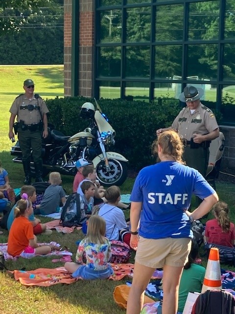 THPCookeville's tweet photo. Capt. Christian, Sgt. Norris, Trp. Bramer, and Trp. Allision talked with the children (future drivers) at the Cookeville YMCA Summer Camp today about the importance of buckling up, distracted driving, and impaired driving. https://t.co/FAuQYkE0Lf