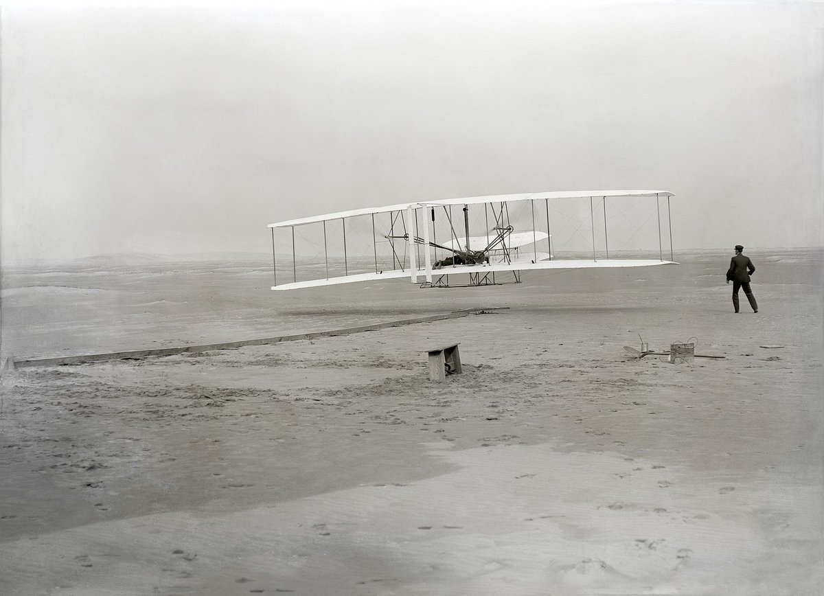 Wright Brother's first flight, 1903 - Kitty Hawk NC. Photo taken by a man that had never used a camera before.
