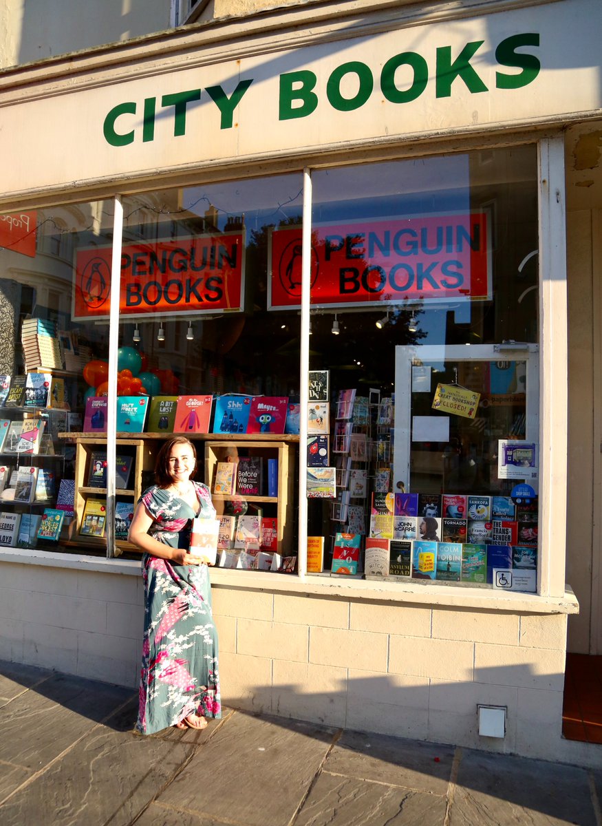 Me, standing outside City Books holding a copy of Pivot.