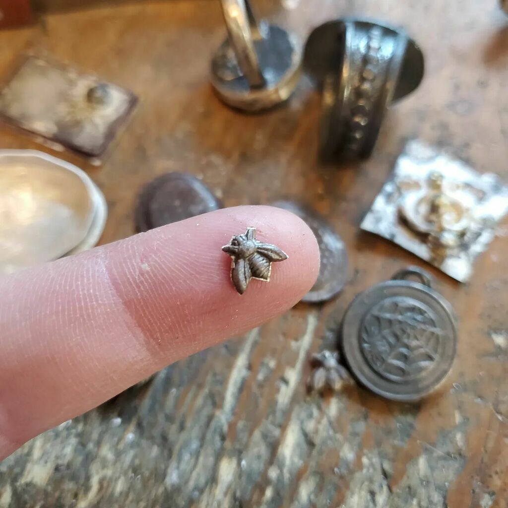 darkmothstudio's tweet photo. I just happened to learn that this week is National Pollinators Week.  And coincidentally I have a couple of tiny bees on my bench that are going to be a part of a pair of earrings.  These little bees are so tiny and so cute! 😍 🐝🐝

#silversmithing #ladysmith #silversmith #me… https://t.co/jmzEFlw6cX