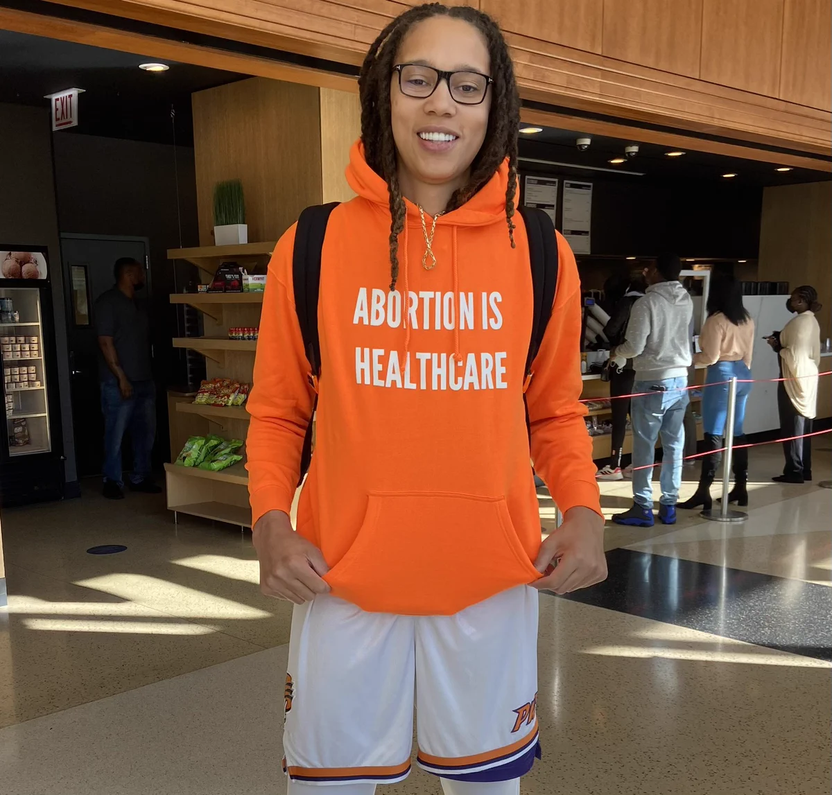Brittney Griner wearing an orange sweatshirt that says “Abortion is Healthcare”