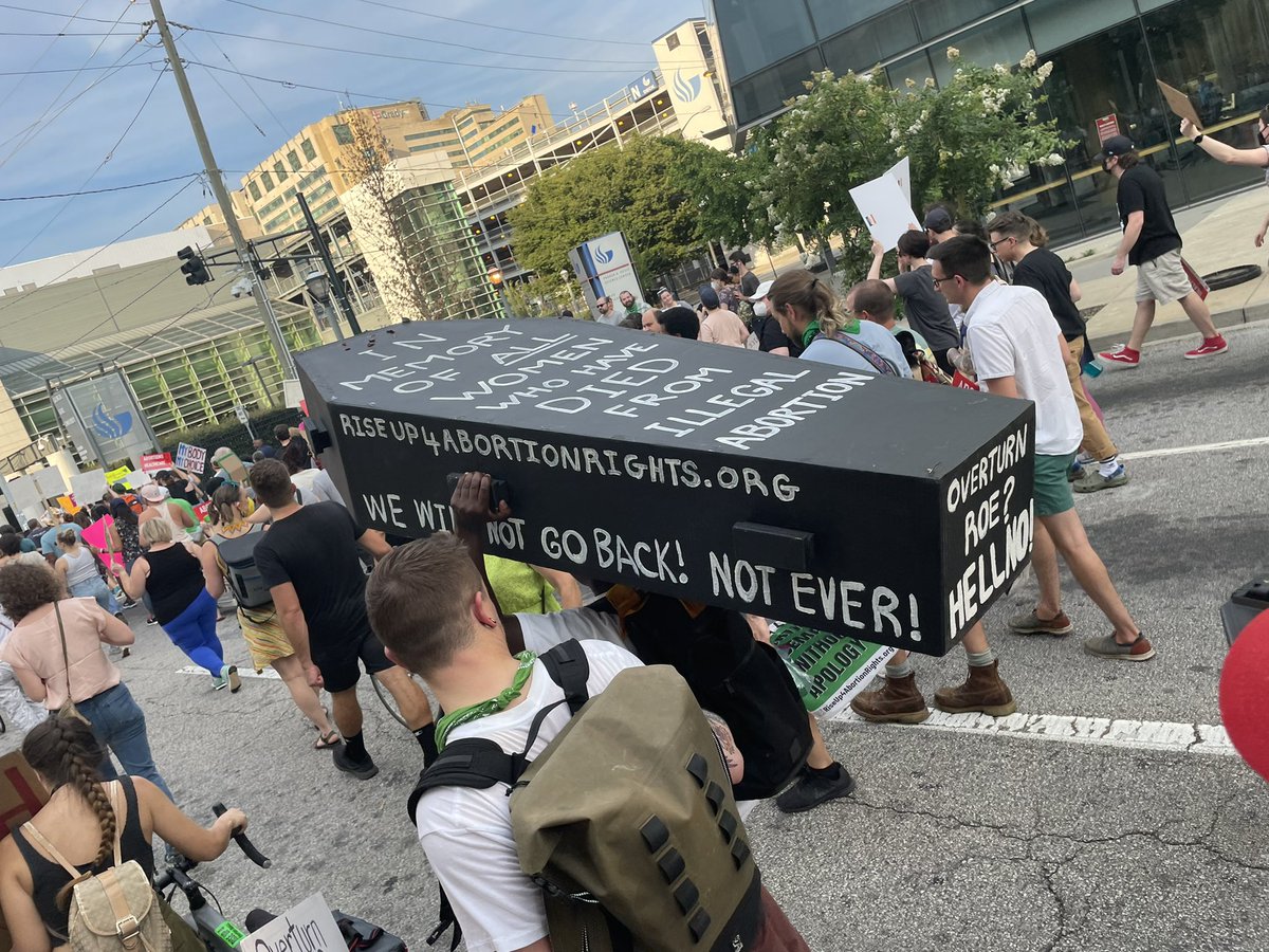 hope_iam's tweet photo. One protestor carrying a coffin down Atlanta streets. It says “In honor of all women who died from illegal abortion.” #11alive #RoeVsWade https://t.co/ypD71WGsBX
