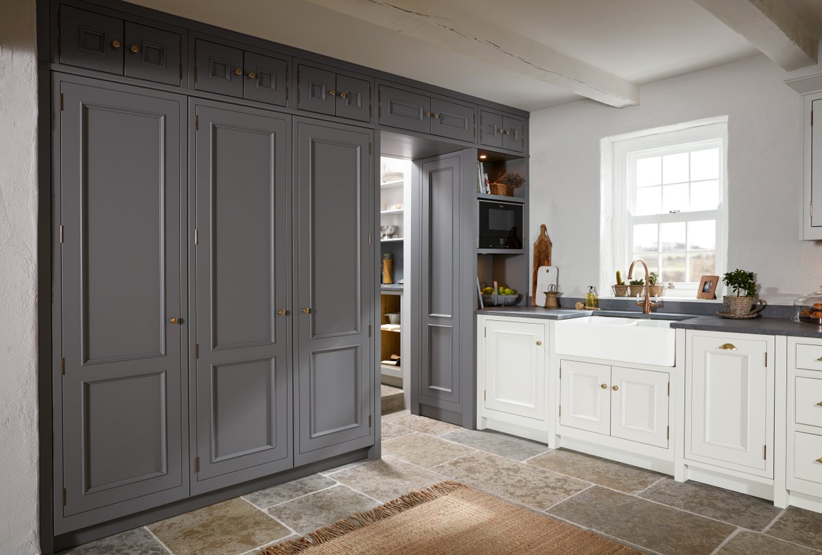 A tall bank of dusty grey cabinets, secretly houses a beautiful double larder cupboard and a walk-in pantry - what more could you wish for 😍 📷 @1909_Kitchens #frederickgeorgekitchens #bespokekitchen #shakerkitchen #greykitchen #kitchenpantry #kitchenlarder