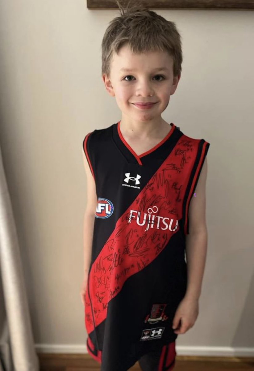 LethbridgeNick's tweet photo. Won this at nab Auskick this morning. George loves it but we are a @CollingwoodFC  family. If I could get my hands on a signed Collingwood jersey I’ll donate this @essendonfc jersey to a charity auction. What do you think Collingwood and Essendon. https://t.co/qDHUxkaq3l
