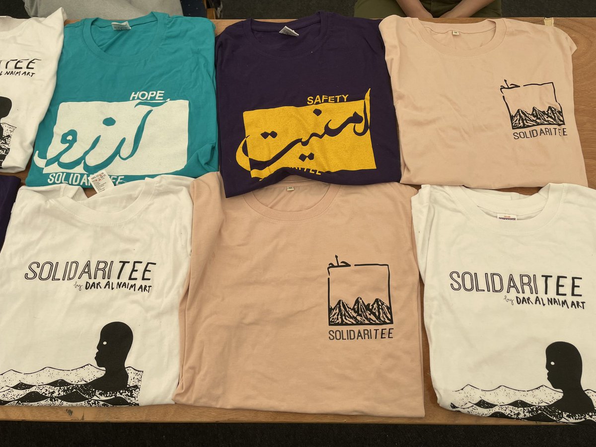 Becca and Beth are representing @SolidariTeeUK - the student-led organisation which works with refugee artists to design bespoke t shirts! #RefugeeWeek2022