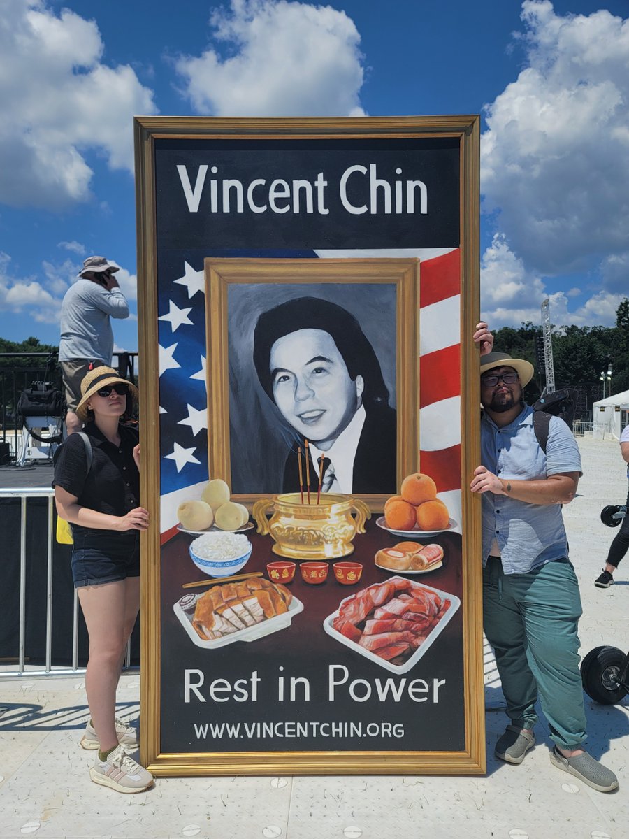 AsAmNews's tweet photo. Arthis Anthony Lee and his girlfriend Adriana Ohar, holding up his latest work for the 40th anniversary of the murder of Vincent Chin. Anthony attended the Unity March in Washington, DC to rise up against hate. #UnityMarch2022 #UnityMarch22 https://t.co/hR8MewZbNd