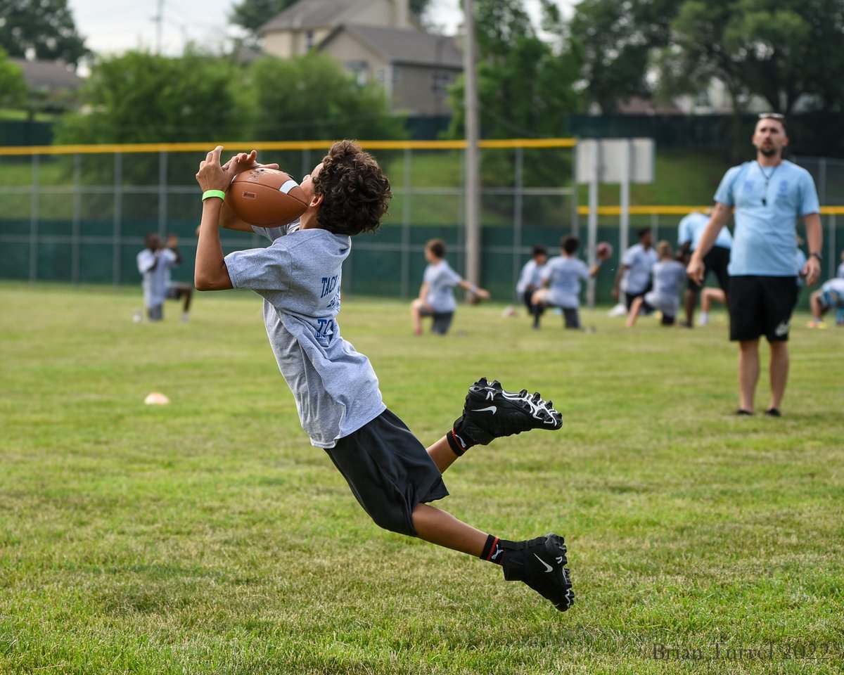 DotteSportsPix's tweet photo. Great event put on today by the @pal_kck, about 150 young athletes at their Tackling Conflict Together football camp. @GehrigDieter looks like a natural coach running drills for young receivers. More pics and story up at https://t.co/diOKCLm7nC https://t.co/LgAqzbbFgR