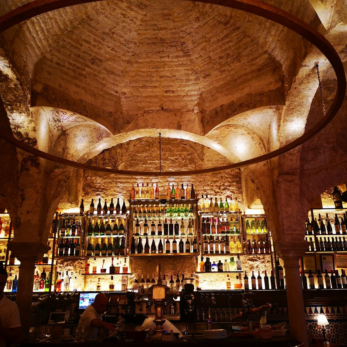 Seville - delicious food in very different settings. Tomahawk Steak in Triana Food Market with the locals and Tapas in an ancient Arabic Hamman now restaurant near the Cathedral. Octopus, Bulls tail, pork cheeks washed down with vino de naranja #deliciousfood #Seville #Andalucia