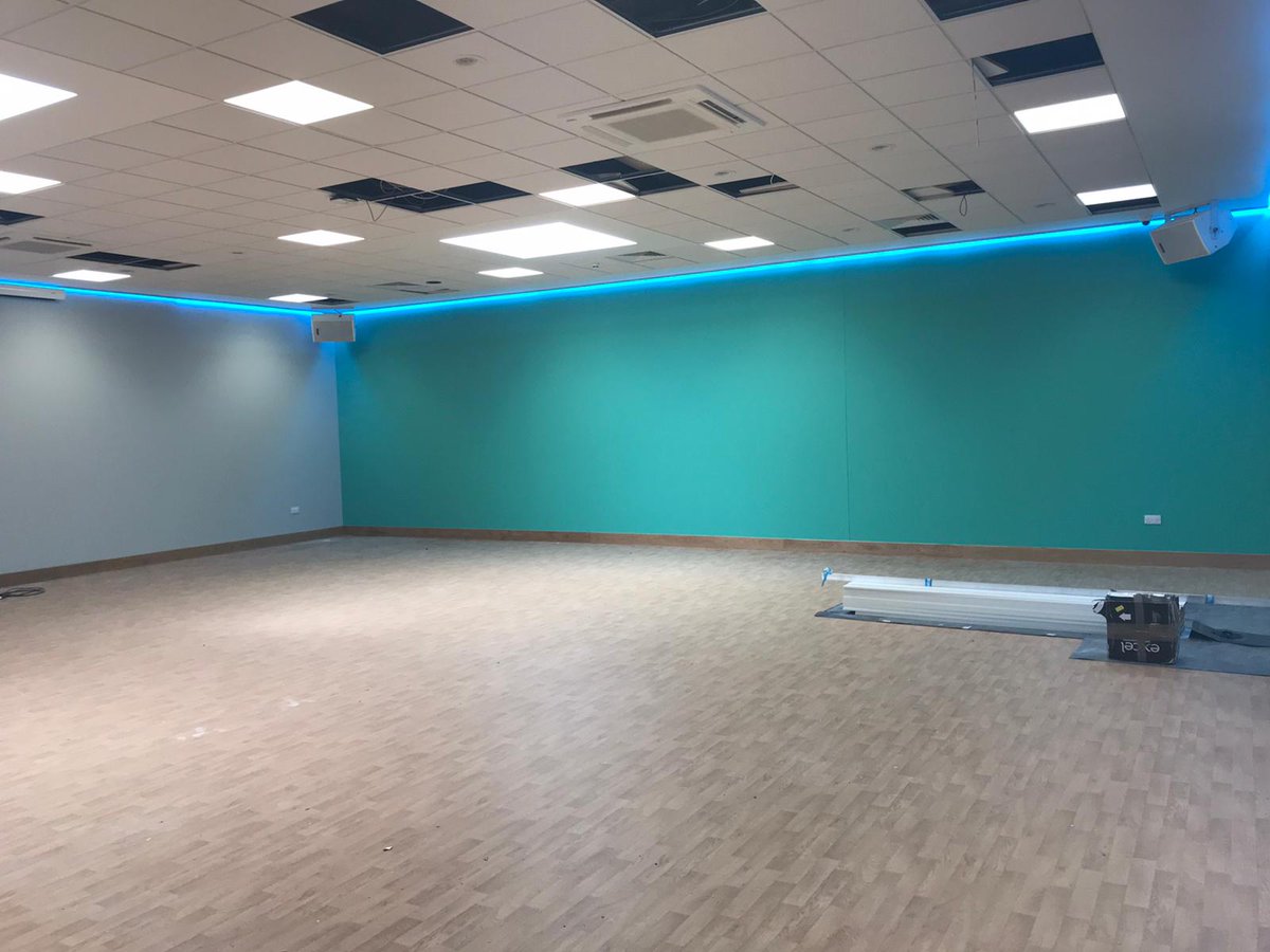 CampusMelksham's tweet photo. Continued progress at the Melksham Community Campus site.  All coming together nicely.  Sports hall fit-out; Wet change nearing end stages; Group exercise studio light testing, and Reception desk installed.  @Sport_England https://t.co/9x7stVuLQr