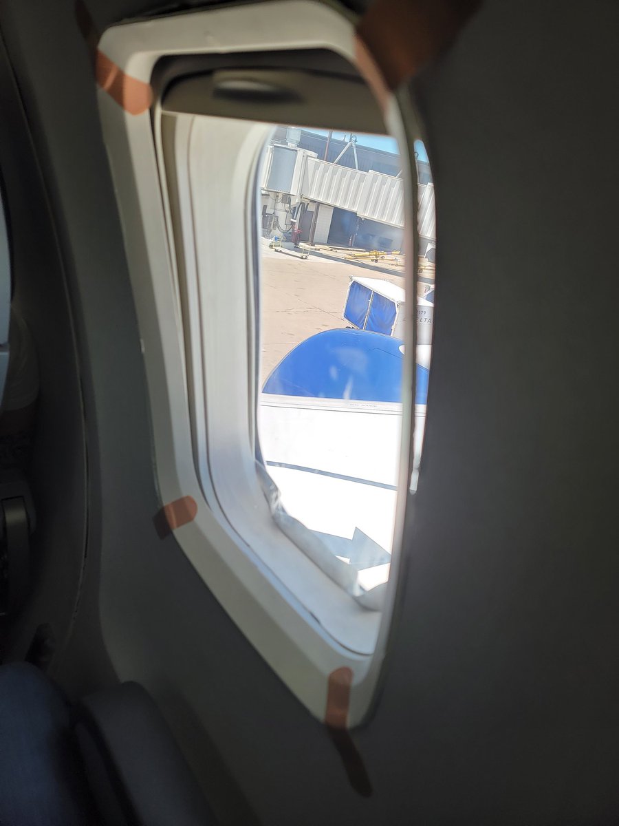 NathanAGreen's tweet photo. @Delta Delta, seriously. As soon as I get on the plane the flight attendant says the WiFi isn't working, nor are any of the headrest screens.  Then I get to my seat and I find this...window combing held in with bandaids? Come on! https://t.co/PfoJmmBuYK