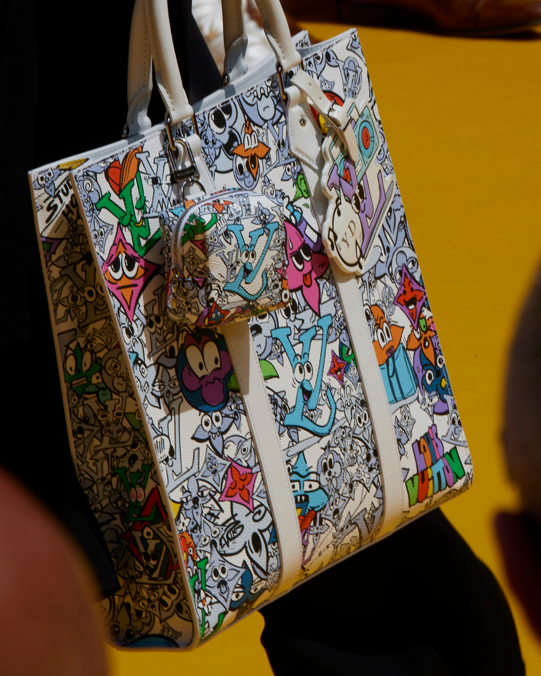 Louis Vuitton on X: #LVMenSS23 Stylistic flourishes. A selection of looks  from #LouisVuitton's newest Men's Collection feature thistle flower motifs  and cartoon graphics. See more from the show at    /