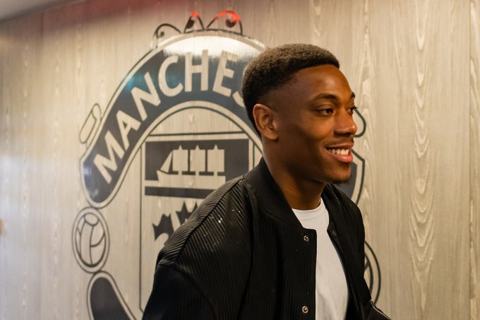 Anthony Martial smiles as he reports back to Carrington for pre-season training.