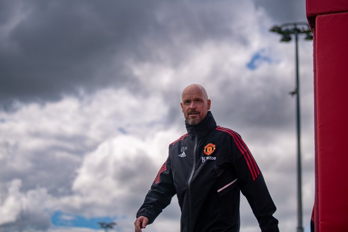 Erik ten Hag looks at the camera as he walks out for his first day of training at Carrington.