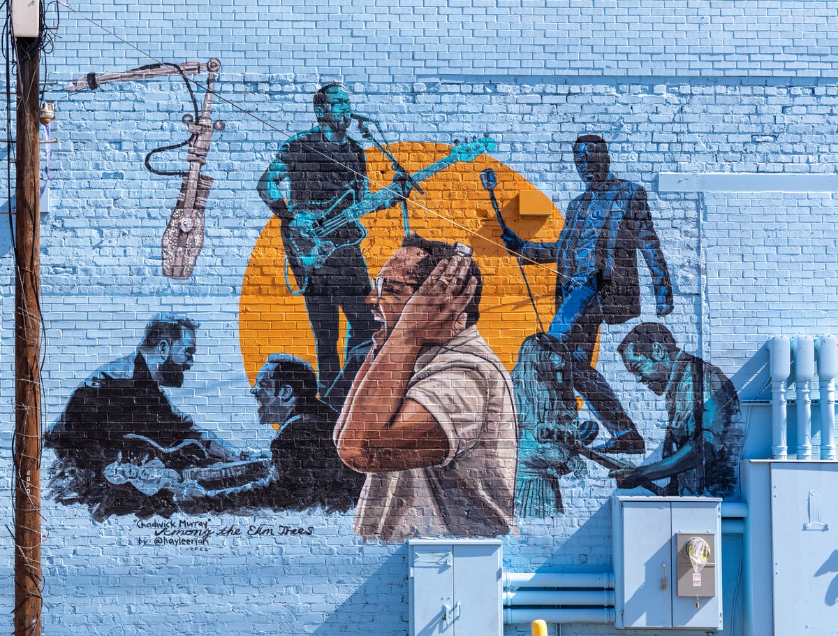 DEF_Texas's tweet photo. For Haylee Ryan's piece on #BluesAlley, she painted her friend, band mate &amp; #localmusician Chadwick Murray, who passed away Sept. 1, 2021. Alongside him in this mural, Haylee was able to beautifully craft in depictions of his bands Whiskey Jar, Mur, Sister, &amp; Bastards of Soul... https://t.co/CjW7eeIsQ1