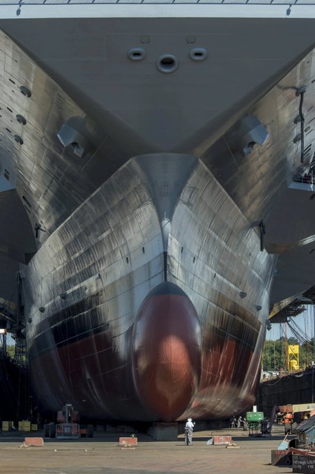 Rainmaker1973's tweet photo. USS Gerald R. Ford (CVN-78) is the lead ship of her class of United States Navy aircraft carriers. Seen here while in the Norfolk Naval Shipyard drydock, it gives an idea of its scale vs humans [source: https://t.co/3rUD8Gx5OY] https://t.co/YOY9f6KwMg