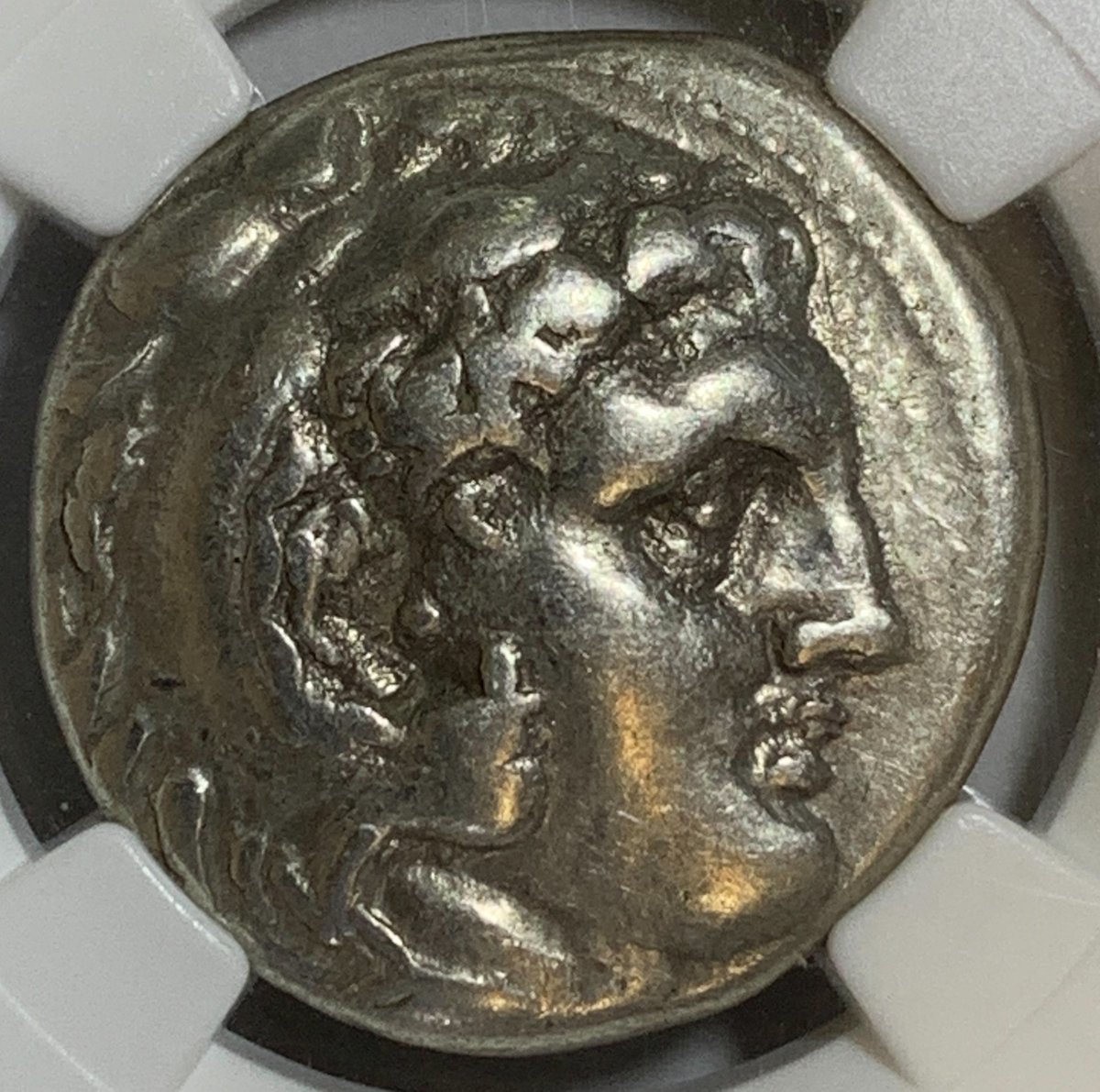BaltimoreCoins's tweet photo. Today's coin is a #Tetradrachm from the Kingdom of Macedon dated 336-323 BC. This coin was minted under Alexander the Great and was graded VF by @NGCcoin. The obverse shows Heracles in a lion skin. The reverse is Zeus seated holding an eagle and a scepter. #coinclub #numismatics https://t.co/dMYKfeLstl