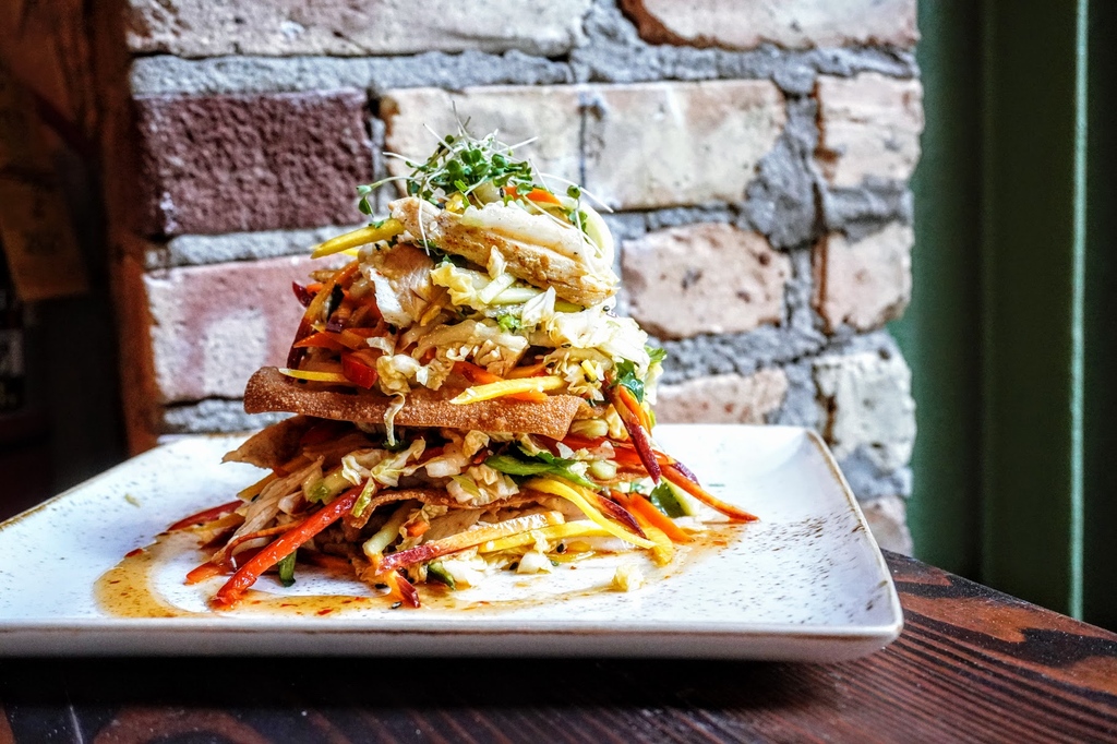 Level up your summer salad! Our Asian Chicken salad is piled high with chicken confit, fresh napa cabbage, cucumber, shredded slaw, green onion, cilantro, topped with spicy red pepper, crispy wonton chips, sesame seeds, &amp; drizzled in a sweet chili vinaigrette. 🥗☀️