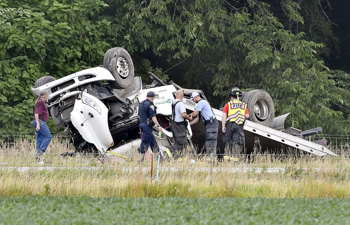 Authorities look over this truck that was involved in a personal injury, rollover accident on I 69 southbound around the 321 mile marker Wednesday morning. The southbound lanes of the interstate remain closed from the Daleville 234 mile marker as the investigation  continues.