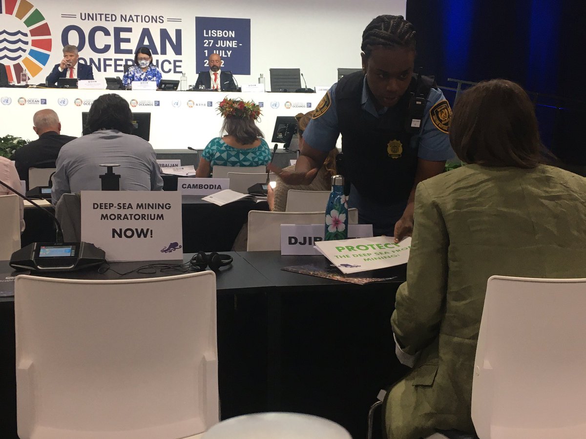 Security removing signs calling for a moratorium on deep-sea mining until more knowledge is available while the panel speaks of the importance of science on decision making… something is wrong here #UNOC2022