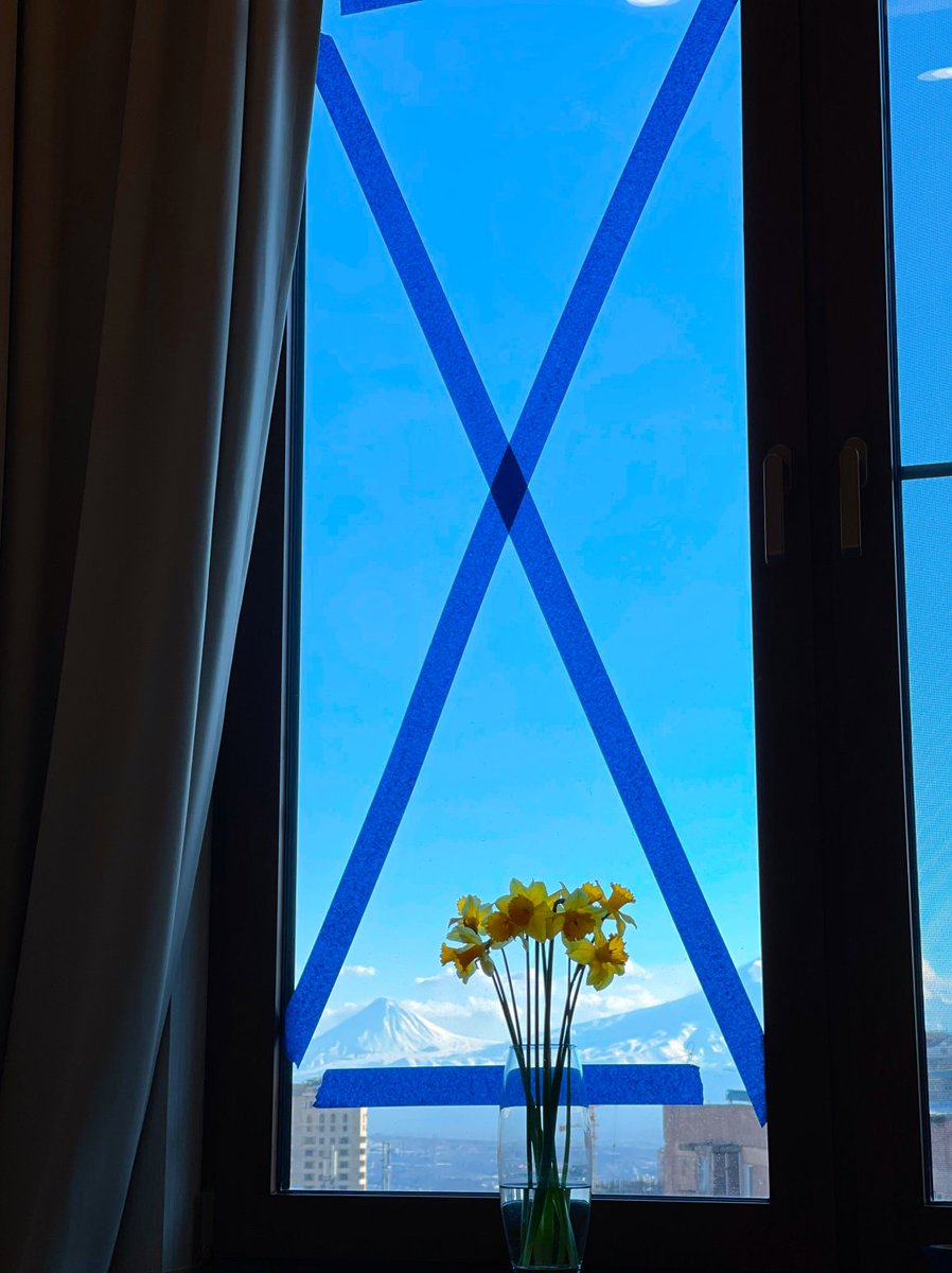 | 312 | Day 124 - 7:01 PM |
Clear blue sky over a snowy mountain peaks behind the window cross-taped with blue duct tape  
 ------
War is still there.  ̶S̶t̶a̶n̶d̶ ̶ stay with Ukraine