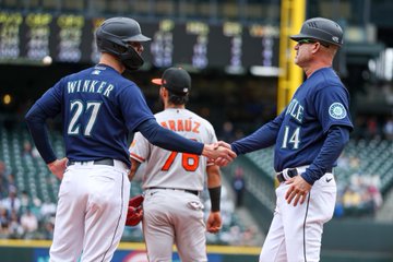 Jesse Winker shakes Manny Acta's hand after getting to third base 