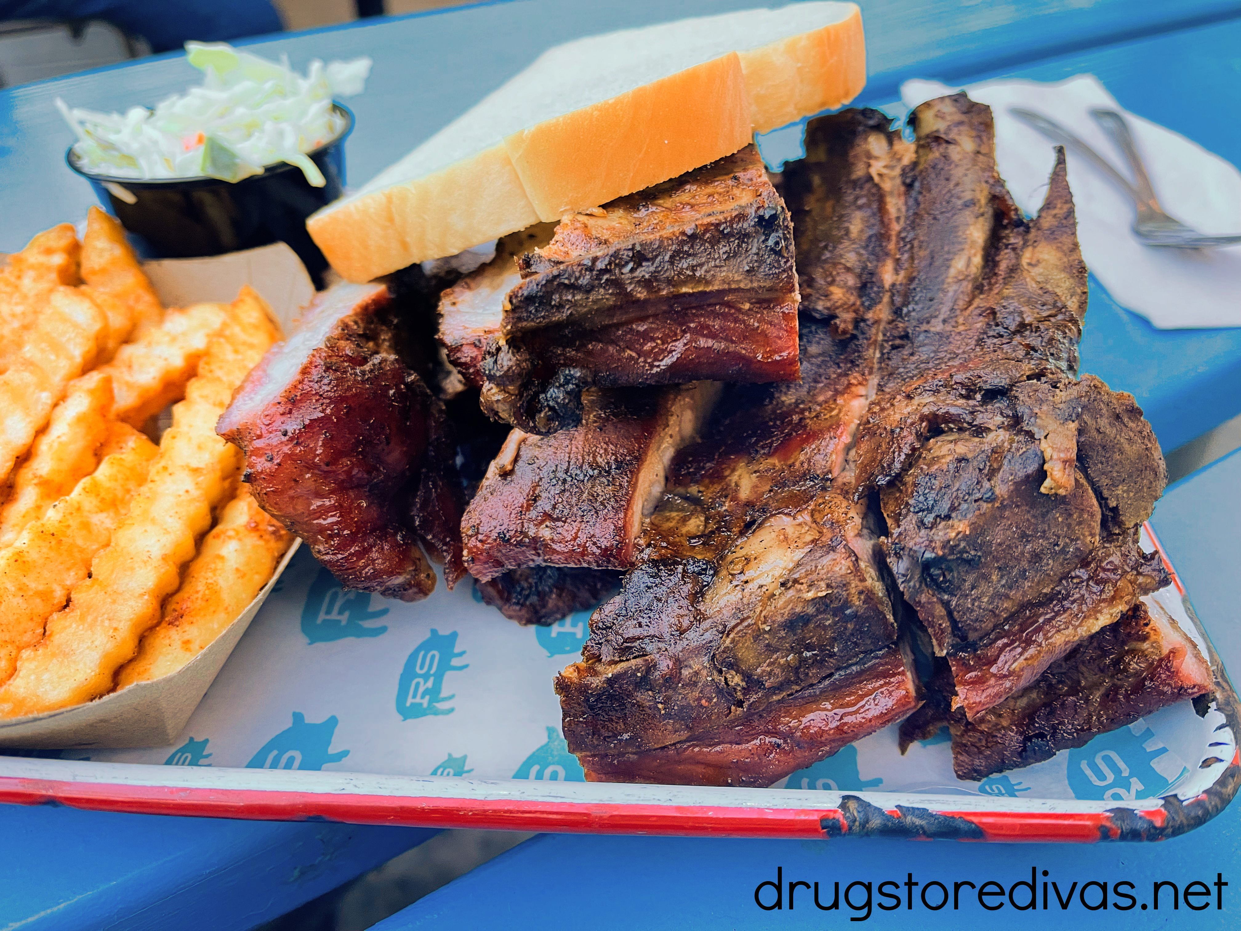 Ribs and fries on a plate.