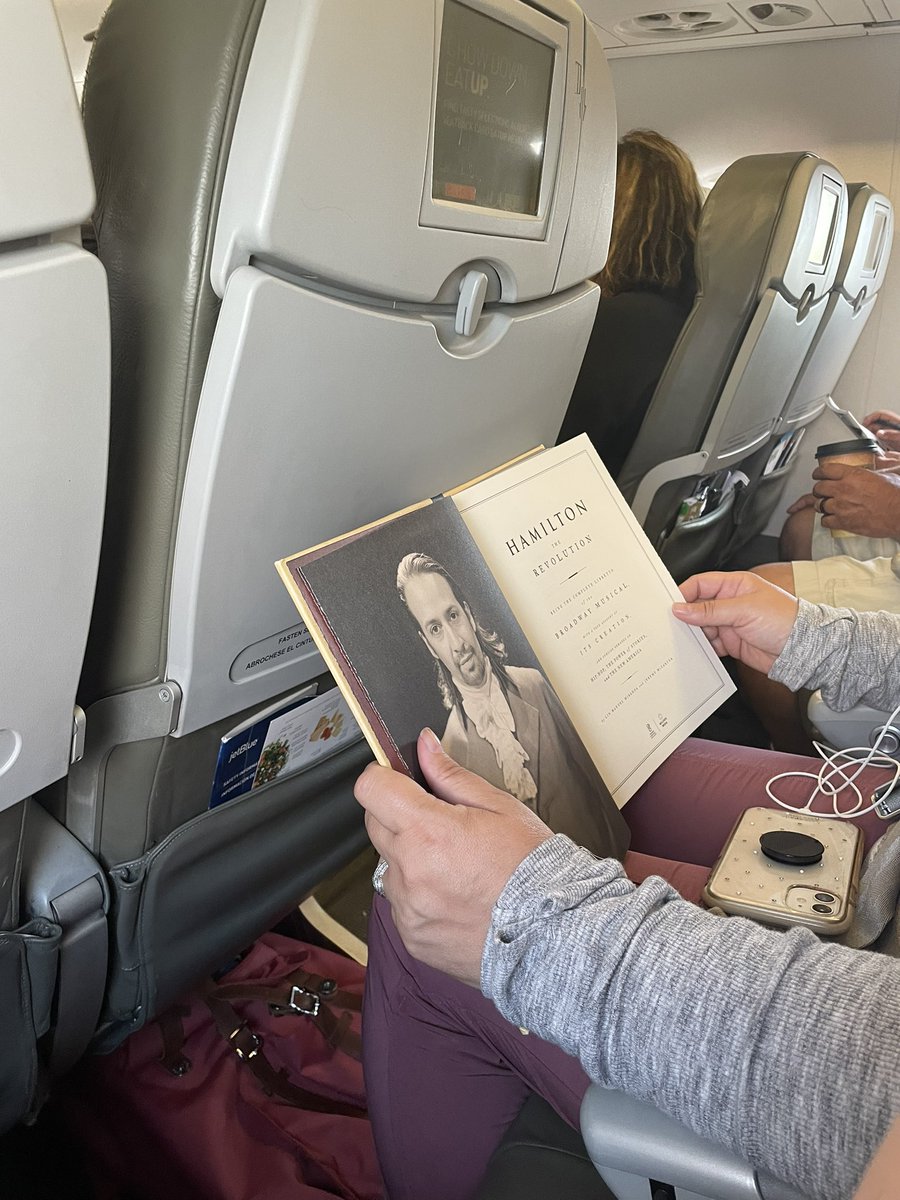 _LisaWithAnS's tweet photo. The person next to me on this flight is reading the #hamiltome in the year 2022, should I make her my new friend? https://t.co/SjNhwHzzxy