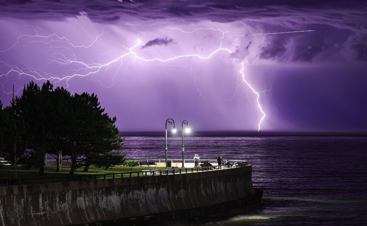 NBC10Boston's tweet photo. Shortly after midnight, lightning strikes in the distance beyond Red Rock Park in Lynn. A line of thunderstorms exited #Boston’s North Shore 30 minutes earlier. Look for a sunny day tomorrow with highs in the 80’s. 📸⁦@pictureboston⁩ https://t.co/Y5yQmI3NQz