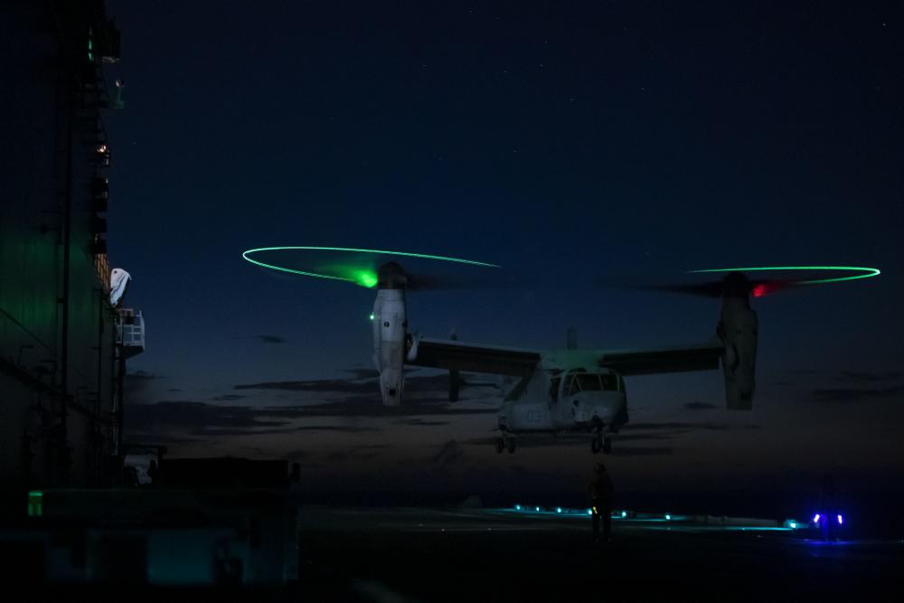 A #USMarineCorps MV-22B Osprey aircraft with VMM-262 turns its rotor tip lights in the dusk as it prepares to take off from the assault carrier #USSTripoli while underway. #7thFleet #BlueGreenTeam #marinecorps #Marines #IndoPacific #FightNow #firsttofight #alwaysready #semperfi